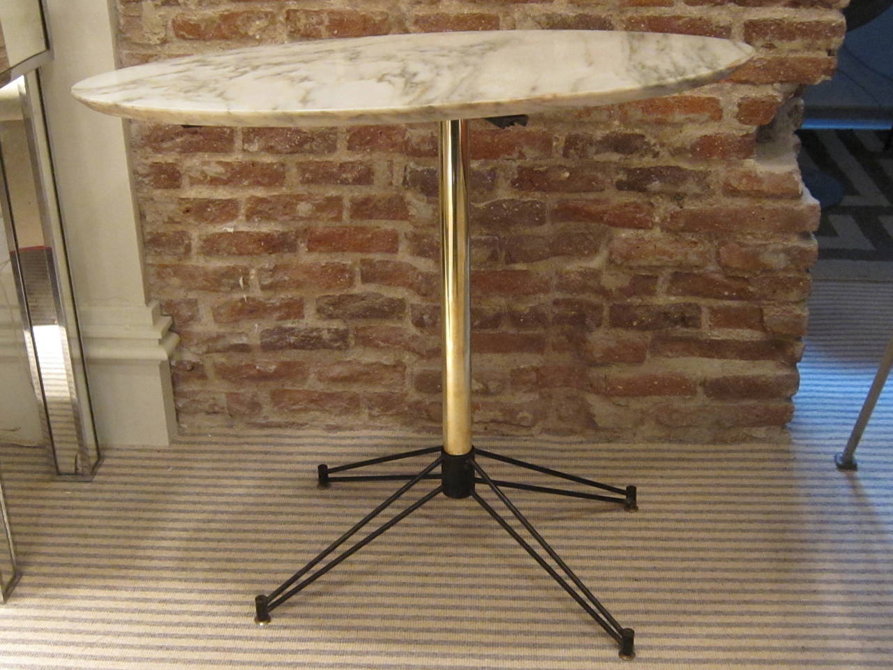 A brass, iron and Carrara marble top oval table. 
