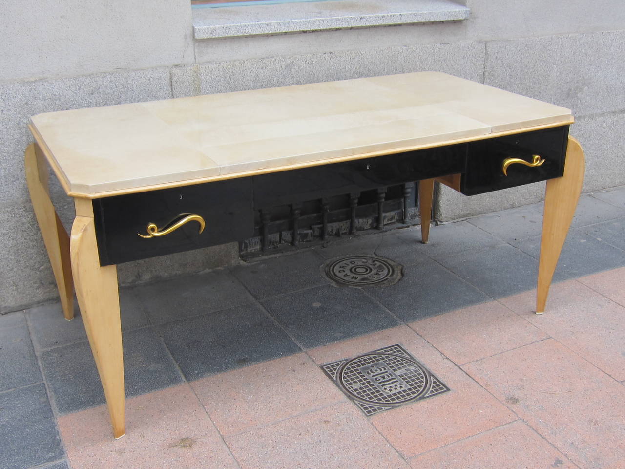 A René Prou sycamore wood and parchment top writing table. France 40'