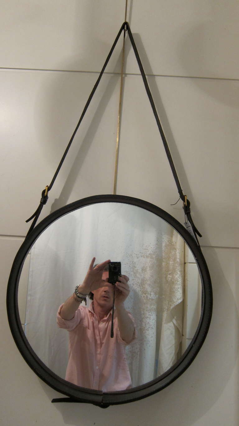 A black leather mirror by Jacques Adnet. France 1960.