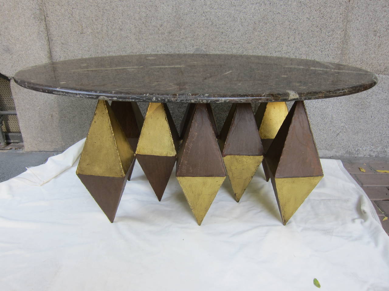 A gilded iron and marble-top coffee table. 2000
