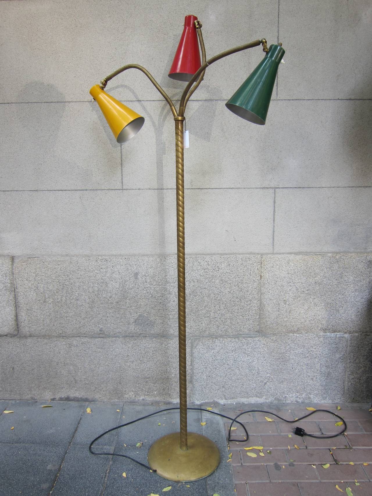 A gilded brass and lacquered aluminum floor lamp. Italy 50'