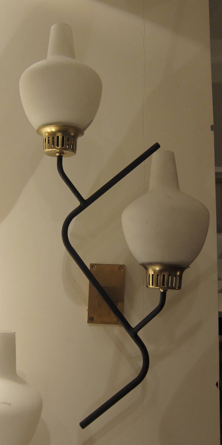 A brass an opaline glass pair of italian wall lights, model 424, by G.C.M.E. Italy 1960