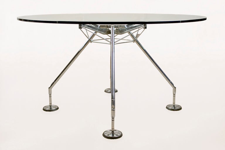 Italy 2005. Nomos table designed by Sir Norman Foster.
Chrome plated steel frame support with a circular glass top.