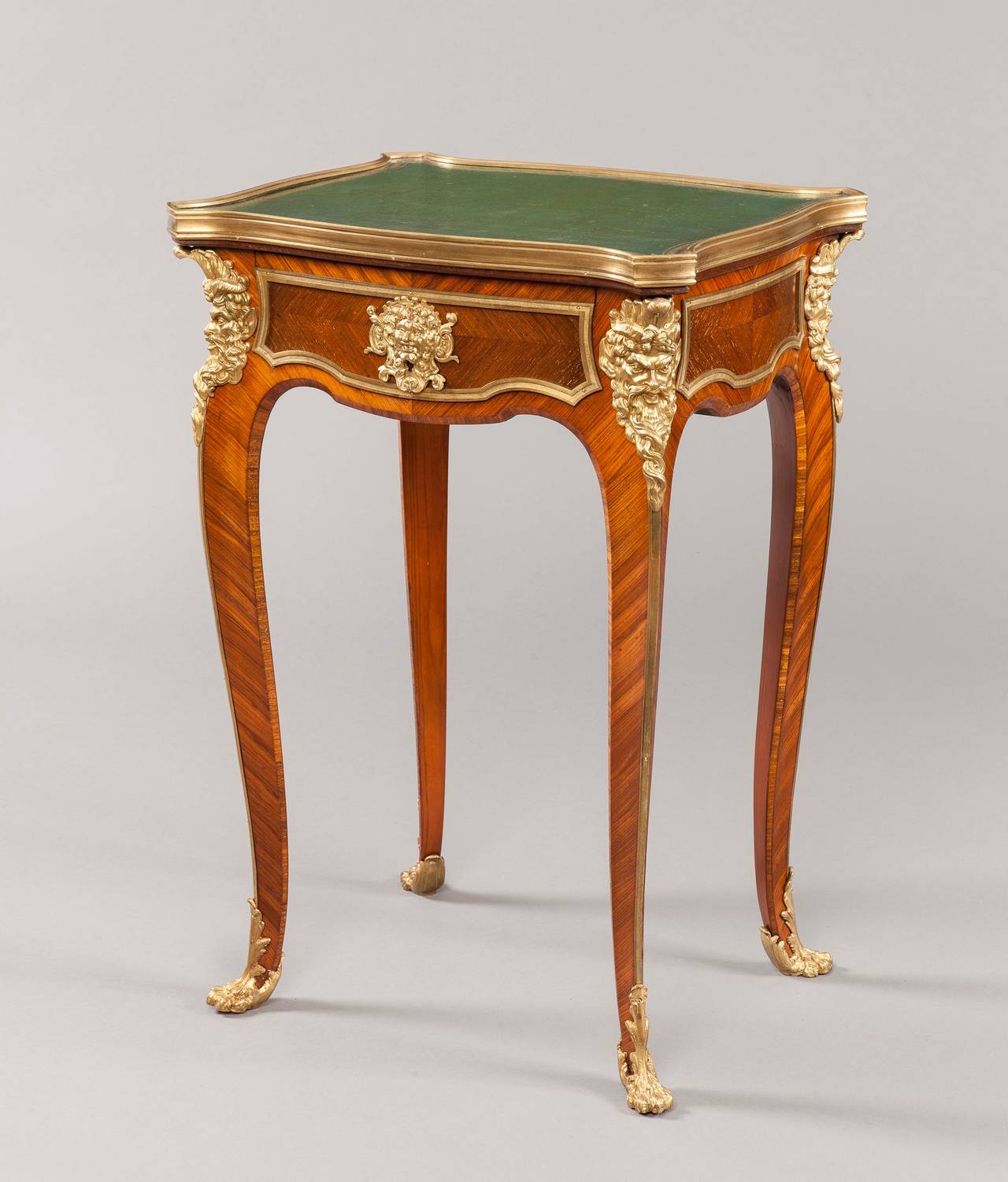 Constructed in kingwood, and dressed with fine quality bronze ormolu mounts; rising from swept cabriole legs adorned with ormolu ‘animal paw’ feet, with ormolu masks of the God Pan at the shoulders; the body houses a single oak lined lockable drawer