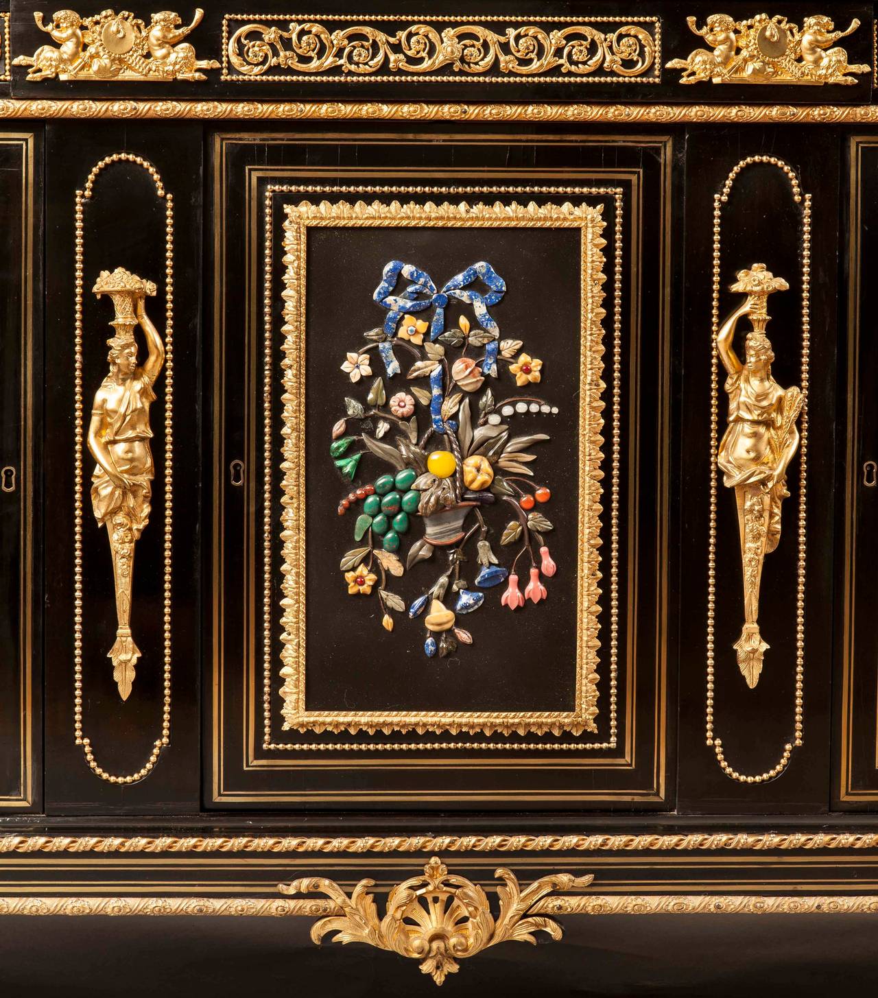 A side cabinet of the French Second Empire period in the manner of Befort Jeune

Constructed in bois norc¸i, inlaid with brass fillets, extensively dressed with gilt bronze mounts, and pietra dura panels.

Of rectangular form, rising from turned