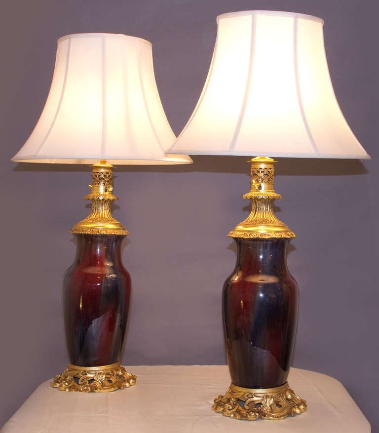 Pair of Flambe Sang de Boeuf Lamps, of important size, dressed with gilt bronze mounts in the Louis XVth manner.