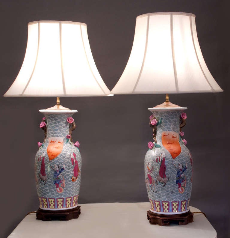 Pair of baluster form lamps, hand decorated with court scenes in polychrome on wood bases.