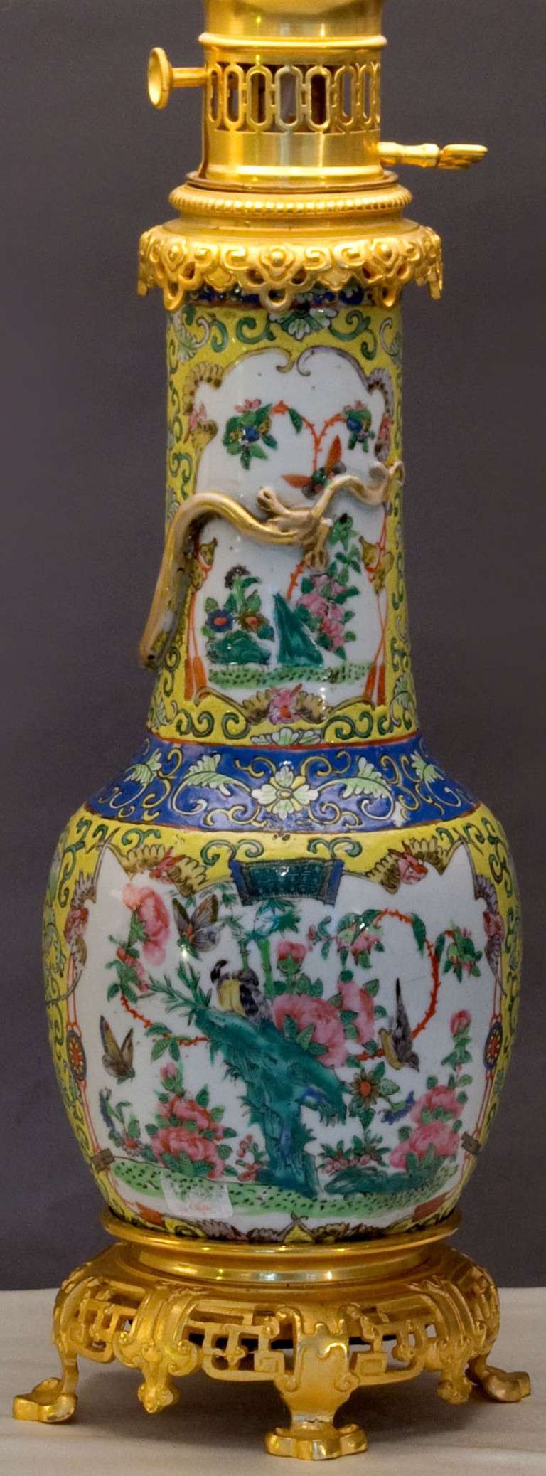 A very fine pair of baluster form lamps in the Famille Jaune palette hand decorated with foliates, butterflies and birds, in polychromes, fitted with gilt bronze mounts. 

Lamps have a white background with yellow, green, blue and red flowers,
