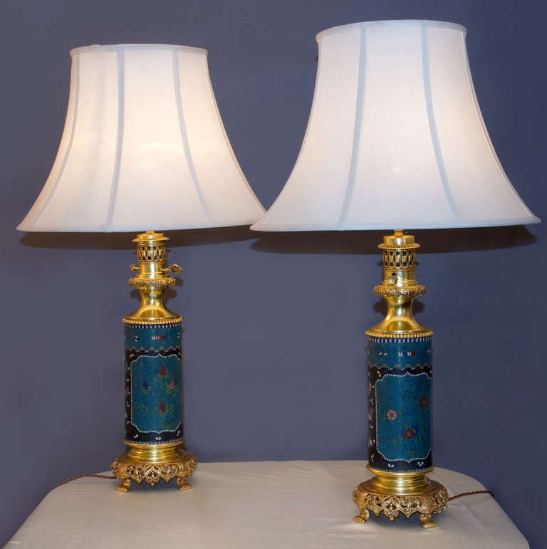 Pair of cylindrical Lamps in Cloisonne with chinoiserie gilt bronze mounts.