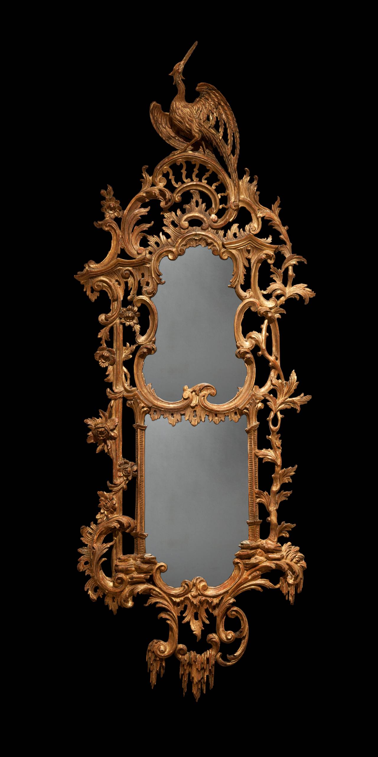 A Pair of Giltwood Mirrors In the Manner of Thomas Chippendale

Constructed in carved gilt wood, the frames, of asymmetrical form, the carving incorporating ‘C’ scrolls, tree trunks, icicles cascades, and surmounted by addorsed ‘Ho-Ho’ birds