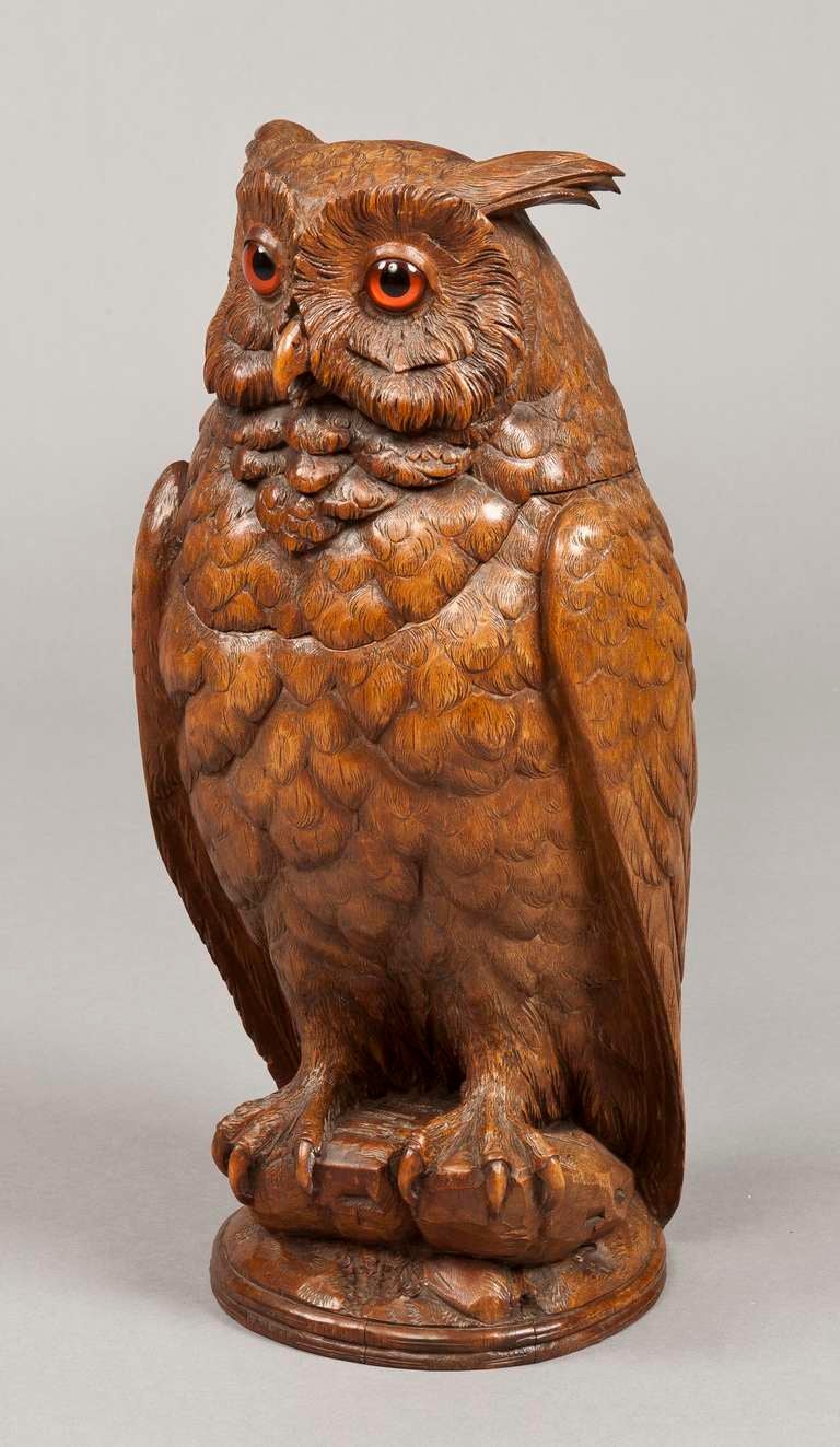 Constructed of carved walnut, the lifelike figure with glass eyes, it���s head hinged, to reveal an hollowed interior container, attributable to Arnold Ruef of Brienz
