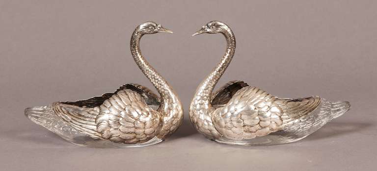 Constructed in the form of male swans, in etched lead crystal glass, and repoussé Sterling Silver, marked ‘Sterling’ and the number 3.