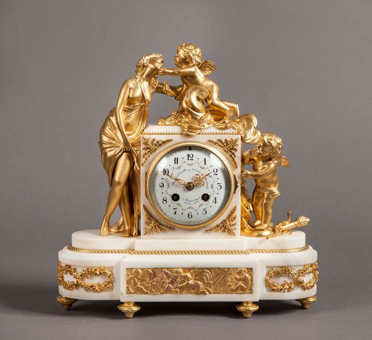 An attractive Parisian mantle clock in the Louis XVI manner
Retailed by the Goldsmiths & Silversmiths Company

Constructed in Carrara marble adorned with fine ormolu highlights; rising from gilt bronze toupie feet, the marble case having ‘D’ form