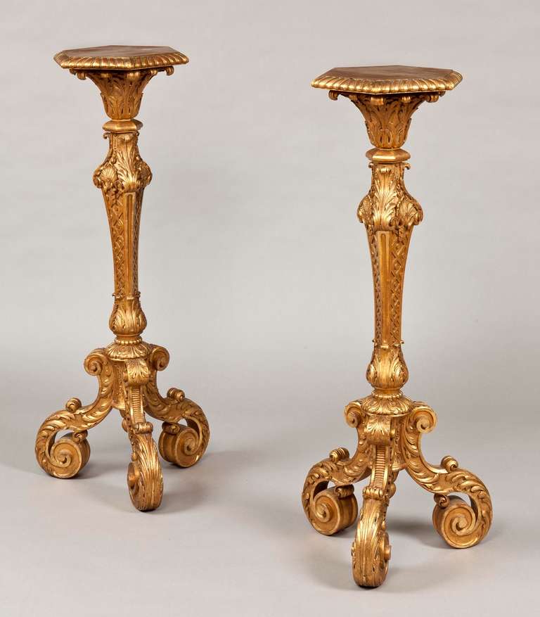 A good pair of candle stands in the manner of James Moore

Constructed in well carved giltwood, rising from ‘S’ form tripartite scrolled feet, dressed with foliates, supporting lotus bud bases, issuing square form columns housing entrelac motifs