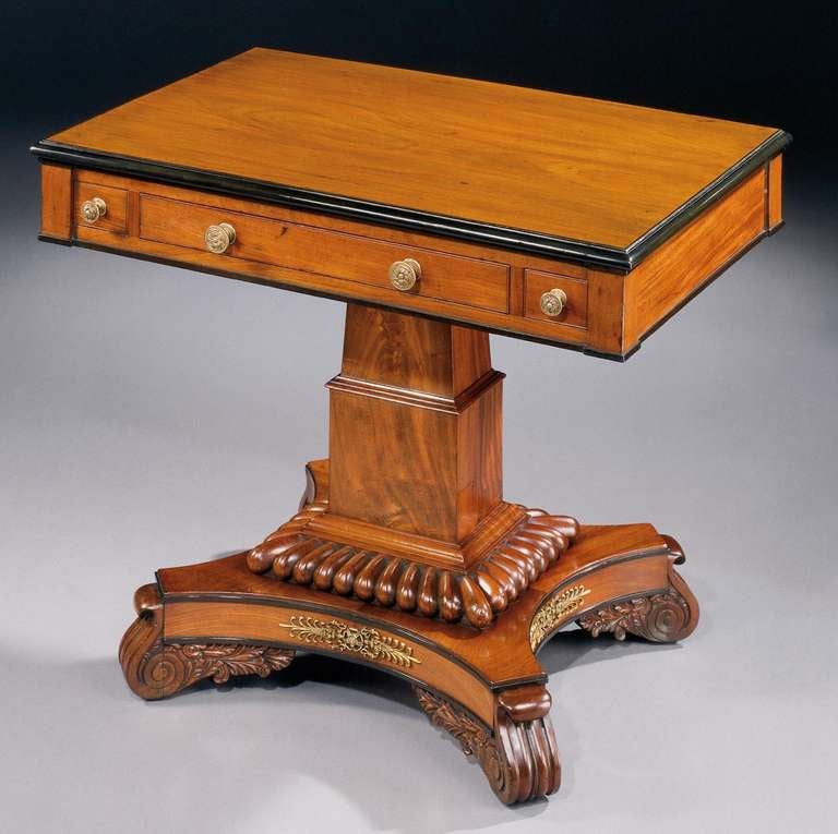 A fine William IV games table.

Of oblong form in softly faded mahogany with an ebonised thumb moulded edge, the diagonally opposed drawers for counters and chessmen flanking the central drawer, which has been fitted with inset chess and