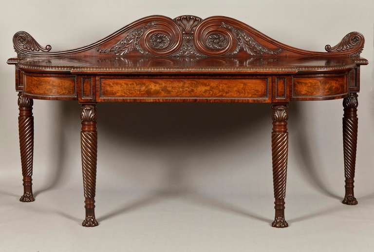 A very fine Georgian serving table of the Regency Period 

Constructed in a Cuban mahogany having richly marked veneers and possessing a deep colour and patination; rising from ‘hairy paw’ feet, the gently tapering legs spirally carved, and ring
