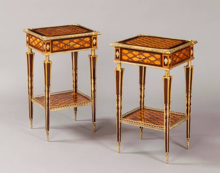 A rare pair of étagères.
Firmly attributed to Donald Ross.

Constructed in kingwood with tulipwood crossbanding, decorated with the typical Donald Ross dotted marquetry trellis work to the upper and lower tiers, having single mahogany lined
