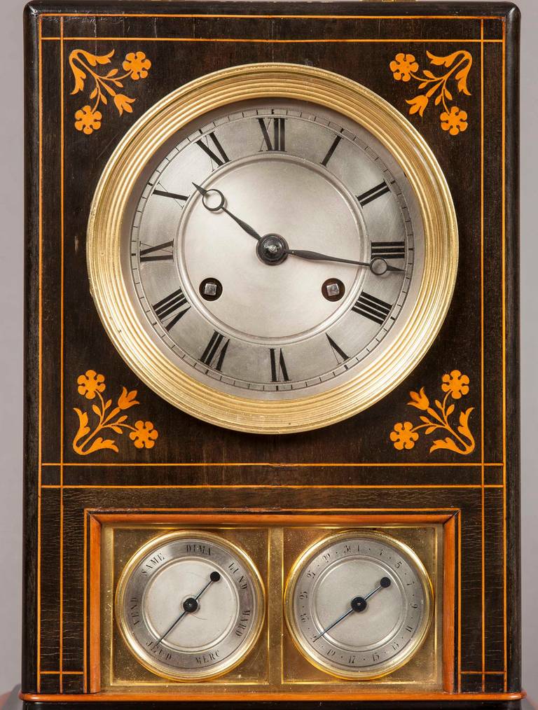 A French mantel clock of the Charles X period.

Constructed in palisander, foliate and line inlaid in boxwood; rectangular form case, surmounted by a gilt bronze carrying handle, houses a circular faced eight day clock with subsidiary dials for