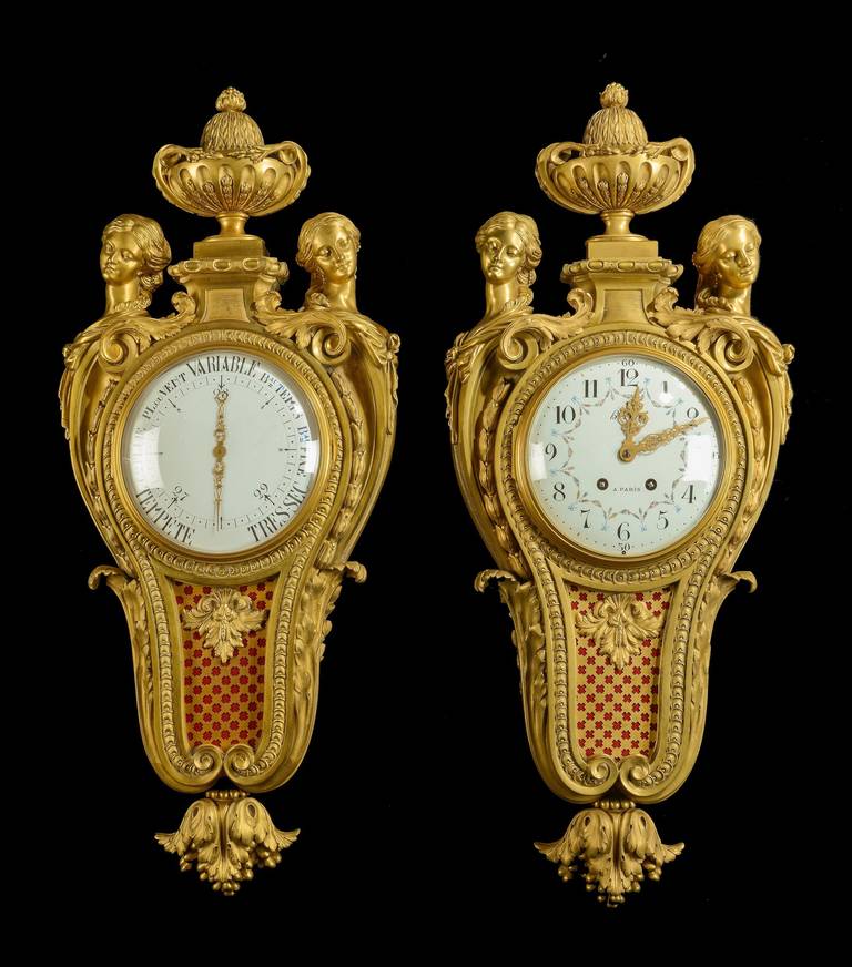 A Cartel Clock and Barometer of the Belle Epoque Period 
By Henri Vian of Paris 

Constructed in finely cast, chased and gilt ormolu cases, the convex enamel circular dials of the clock, and also the barometer hand painted with floral swags, and