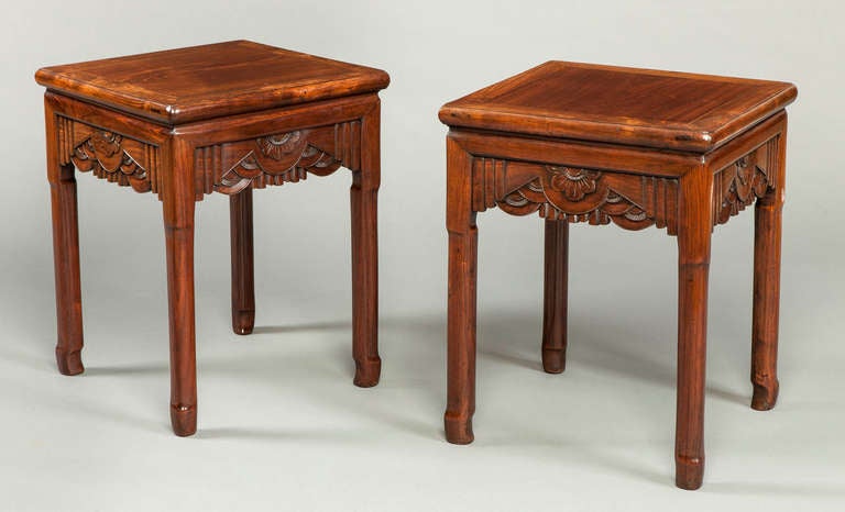 A good pair of Chinese end tables. Constructed in Huanghuali wood; the tops of square form, with radiused ends, the vertical shaped legs conjoined by carved ‘curtains’ and foliates.