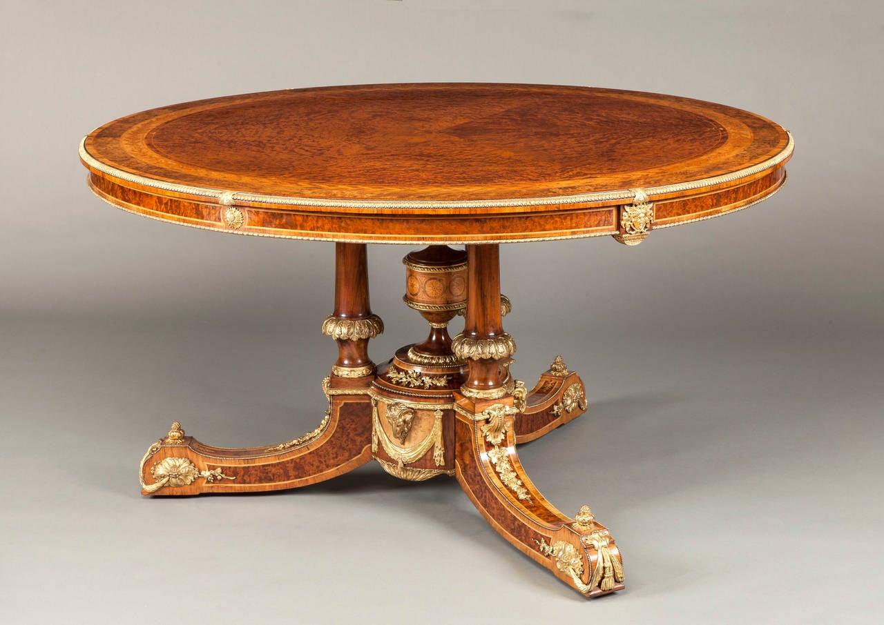 Constructed in thuyawood, with satinwood and tulipwood used in the cross banding and inlays, and having finely cast ormolu mounts used in counterpoint; the tripartite downswept legs terminating in recessed castors, with shells and draped leaves to