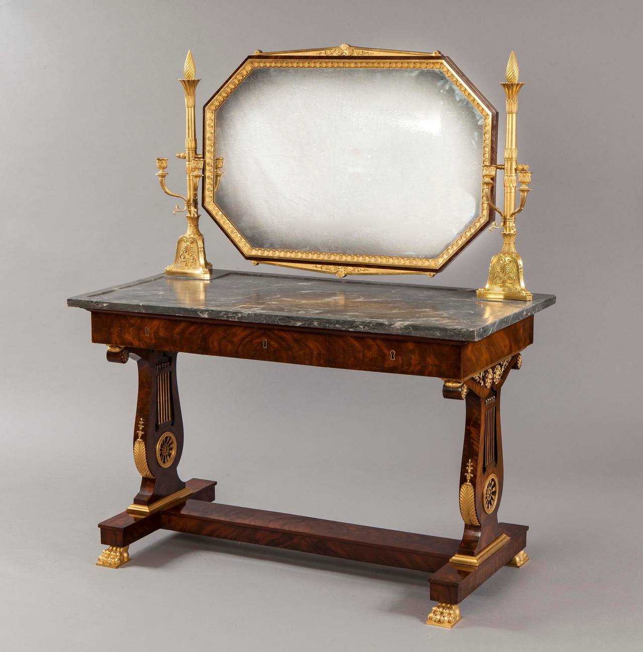 Constructed using a fine Honduras mahogany with gilt highlights, Bleu Tarquin marble and richly dressed with fire gilt ormolu mounts of the highest quality. The table of lyre end support design, rising from ormolu claw feet, conjoined with a