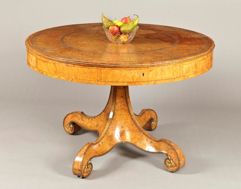 An attractive drum top library table by William Freeman of Norwich

The design of this centre table is drawn from the noted work of Richard Bridgens and constructed in pollard oak and gilt bronze; rising from a quadripartite scroll footed base,