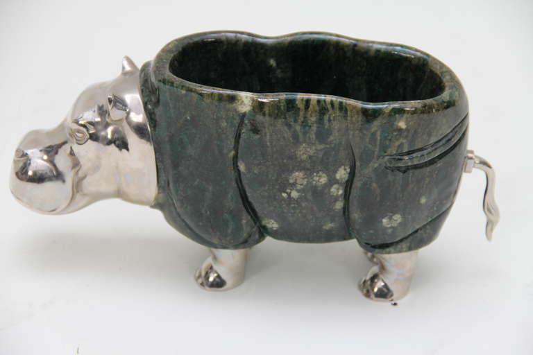 A green jadeite hard stone mounted on silver plated metal in the shape of a hippopotamus
