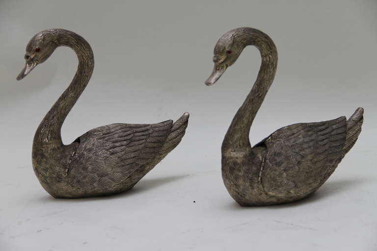 A pair of silver plated metal flower jardinieres in the shape of swans