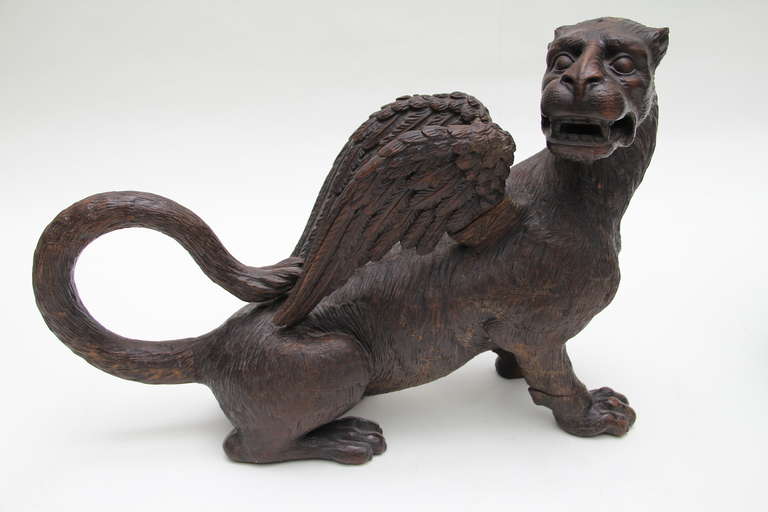 A pair of carved oak wood winged lions from the collection of Duarte Pinto Coelho