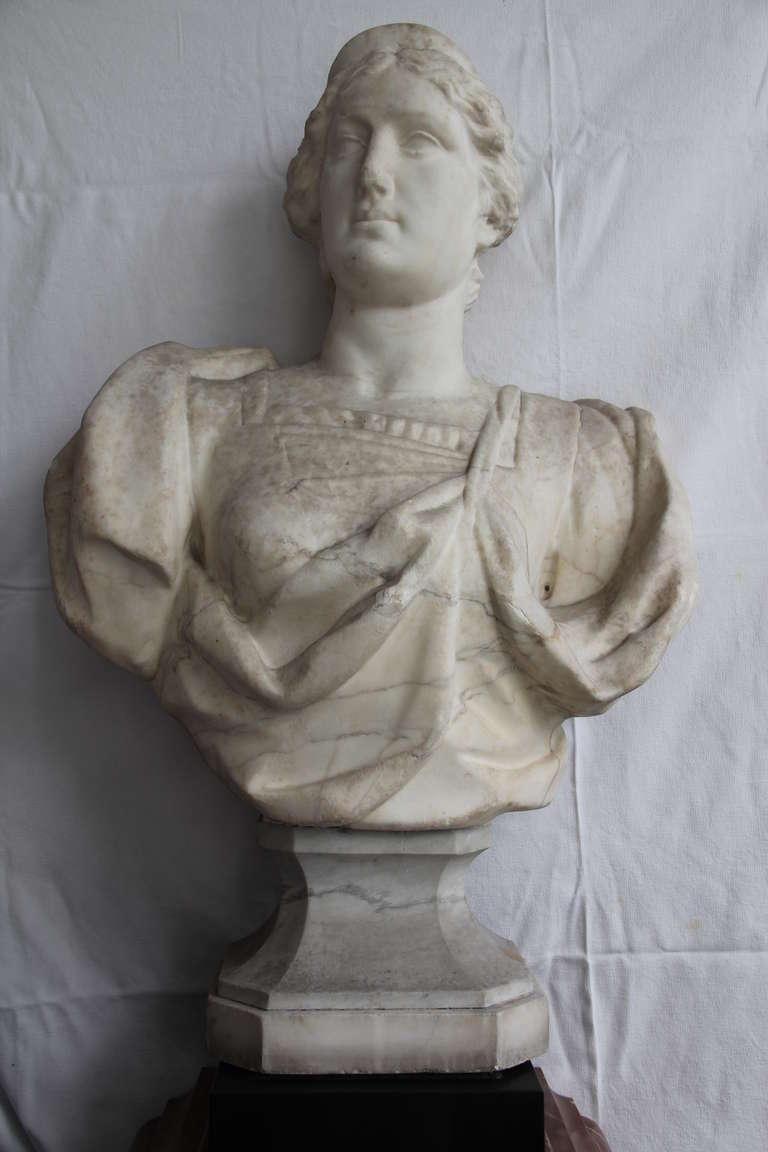 A Carrara white marble female bust.
