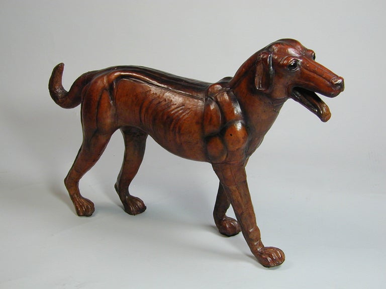 Leather model of a dog in naturalistic pose.