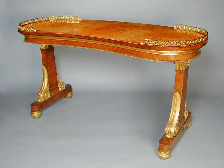 Regency amboyna and giltwood kidney shaped writing table