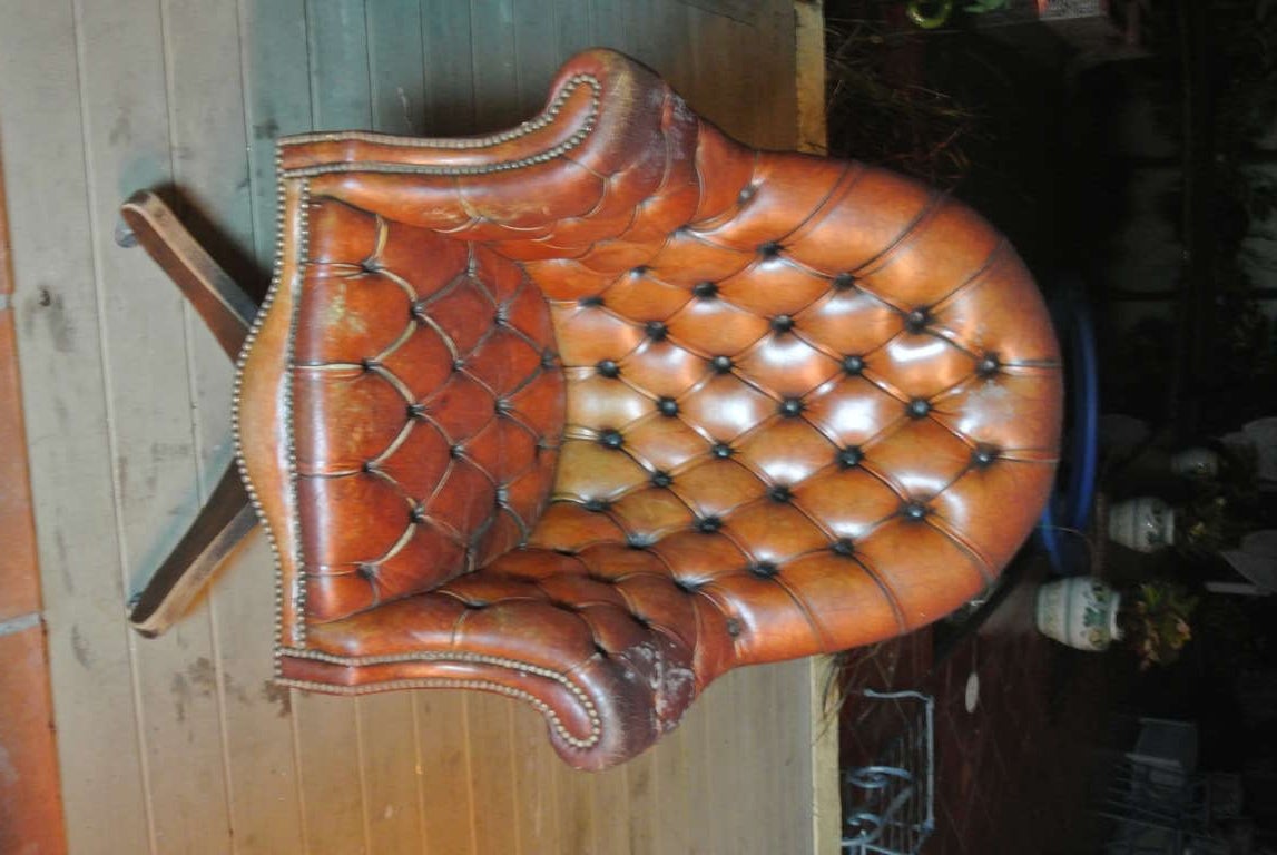 Antique English hand tufted leather  swivel task chair. Old leather and nail head upholstery over aged wood base. Looks great in its old surface or could benefit from new upholstery.