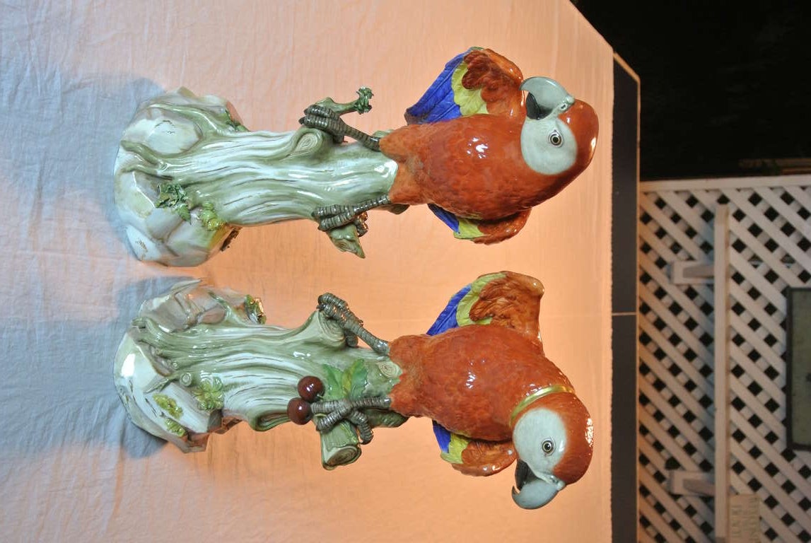 Beautiful right facing and left facing Meissen porcelain parrots of fine detail and great color. They are standing on tree stumps with foilage. The graduated colors are clean and brilliant. Both marked Meissen. These were mounted as lamps at one