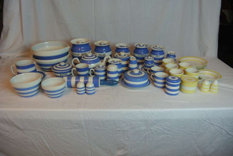 Collection of yellow and white and blue and white Cornish Ware comprised of serving, baking and storage pieces. Set contains desirable lidded canisters with script and rolling pin.