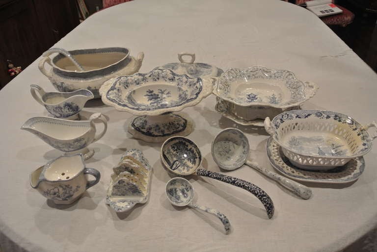 Group of hard to find blue and white transfer ware serving tureens, gravy boats, napkin holder and ladles. Two serving bowls with under plates.