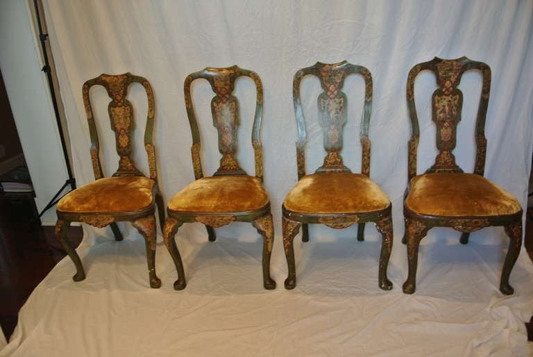 Set of four Baroque chairs with original painted decoration. Deep olive green with Venetian red trim. Rich amber gold velvet seat covers on original frames.