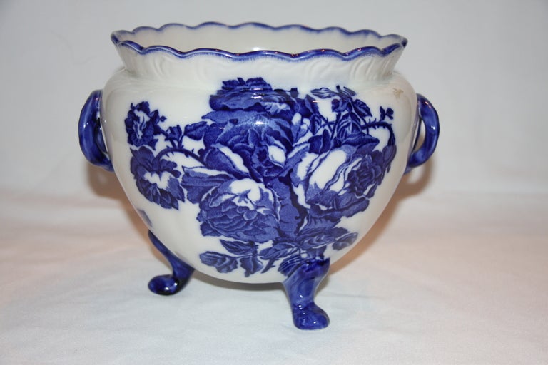 Blakeney English Ironstone Vase
Staffordshire
Early 20th Century
Transfer printed with blue flowers on three paw feet.

Diameter 10 inches