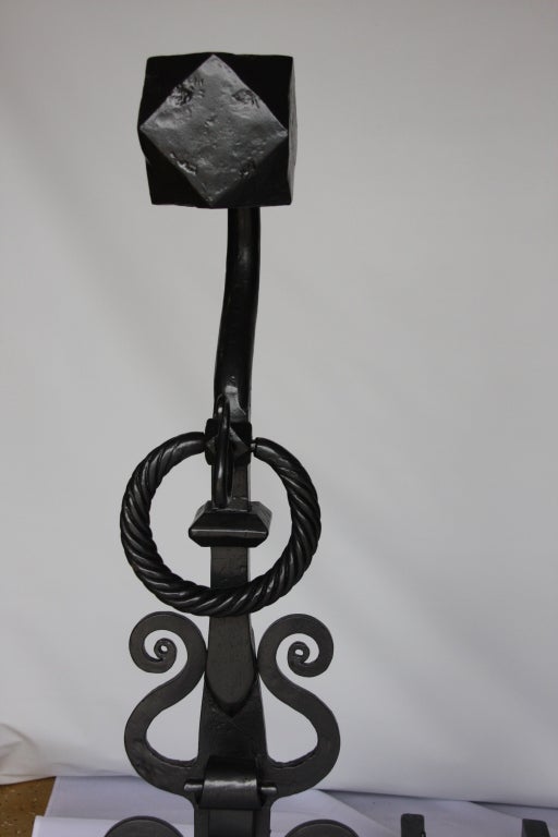 Pair of Renaissance Style Iron Andirons. Circa 1850. Each with a faceted finial on shepherd's crook upright, hung with rope-twist rings and applied at the sides with S-Scrolls on two S-scroll feet with diamond pads. Notice how beautiful the Andirons