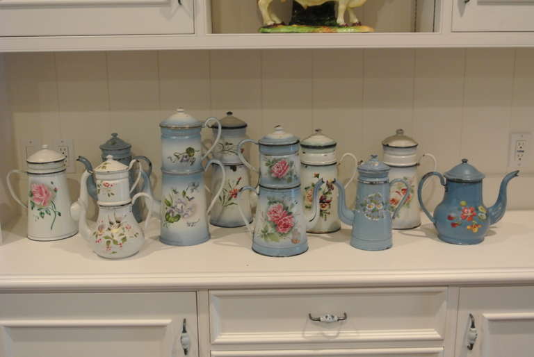 Lovely collection of ten antique enameled tin coffee pots with floral motif.