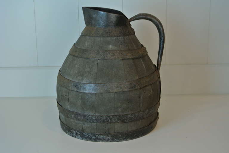 Great old metal and wood pitcher.