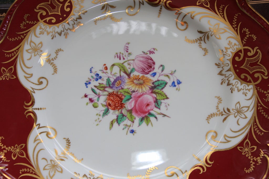 Set of 12 English transferware and painted porcelain dinner plates. Second quarter of the 20th century. Marked 