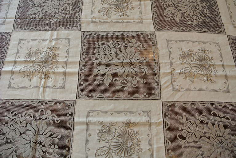 Stunning set of antique lace and linen tablecloth with matching napkins. This set is truly special in its quality and design. Nearly half of the tablecloth is a very fine lace in an overall checkerboard pattern. 12 napkins in toatal.