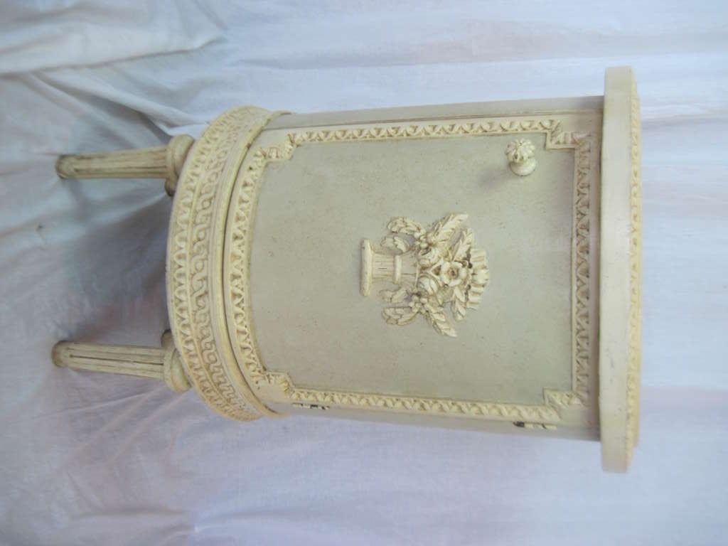 Classically inspired end tables or night stands. They are well suited to living room arrangements or beside the bed. The pair is detailed and finished all around to float in room. Floral motif on each door and edging with classic details. Opening