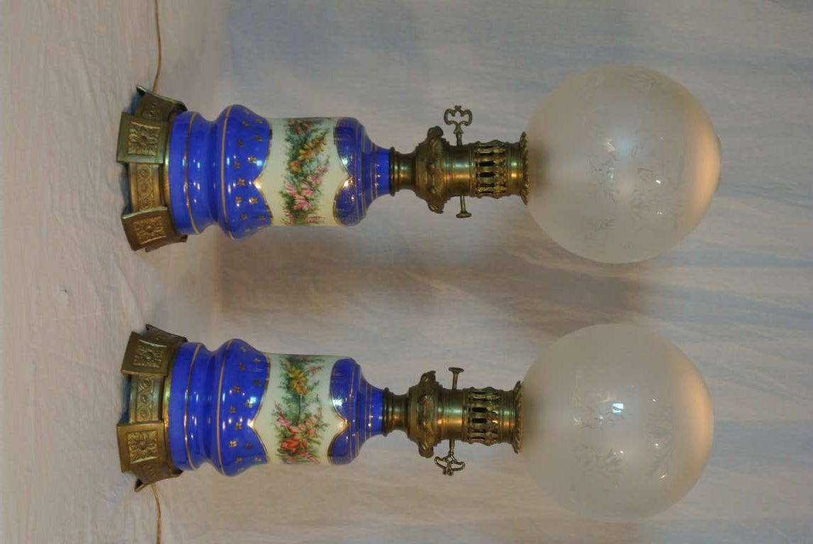 Antique gas lamps that have been electrified long ago. Replacement shades with vintage style has frosted finish with see through floral pattern. Original porcelain glazed a brilliant Prussian blue with the middle inserts of white with hand painted