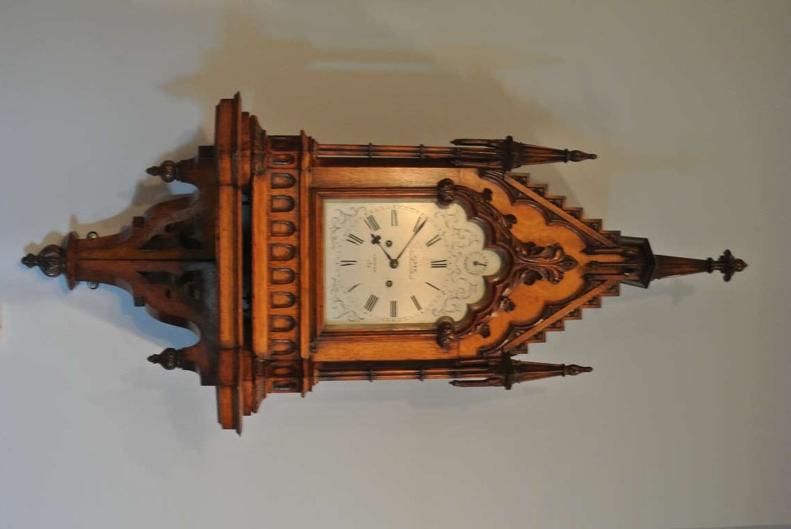 Rare Victorian Gothic wall clock on original bracket. The arched pediment case with Gothic tracery encloses a 6 3/4 inch steel dial with Arabic numerals, signed, beneath a strike silent dial. Pierced fretwork sides. Viner, New Bond St., London 2/238