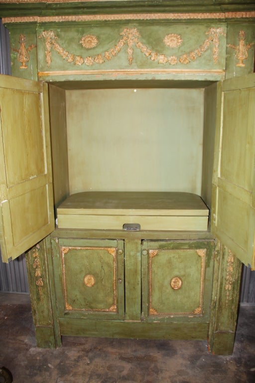Antique Painted Green Linen Press from the Howard Kaplan Collection. Adams style, with original gesso moldings.  Later retro fitted with pull out swivel inside upper cabinet for a entertainment systems. Some professional restoration to moldings.