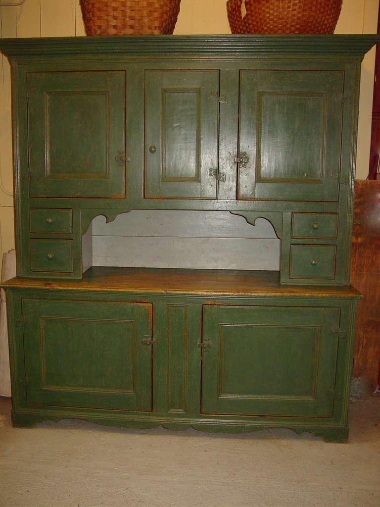 A Green Kitchen cupboard with five doors and 4 small drawers