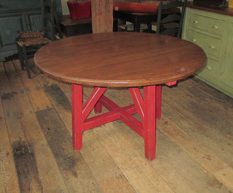 Round pedestal table. The top has a beveled edging.